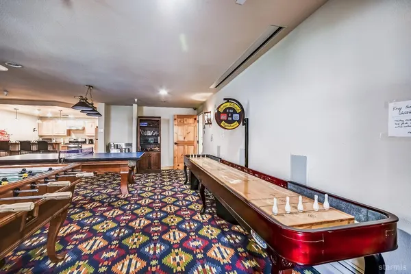a kitchen with stainless steel appliances granite countertop a stove refrigerator and a dining table