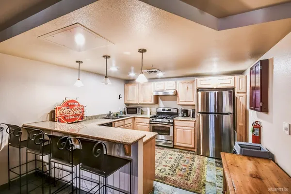 a kitchen that has a sink a stove top oven a counter space and cabinets