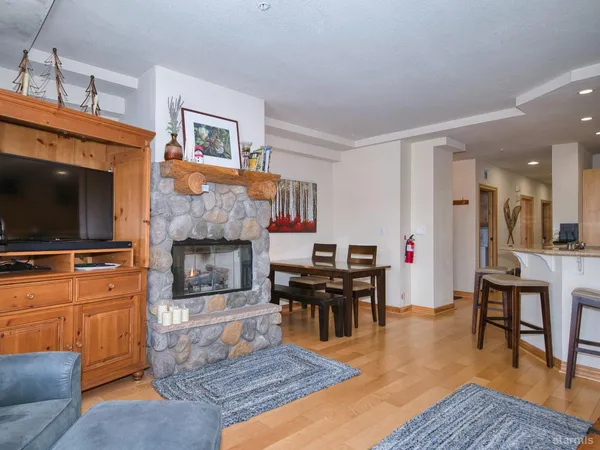 a living room with furniture a flat screen tv and a fireplace