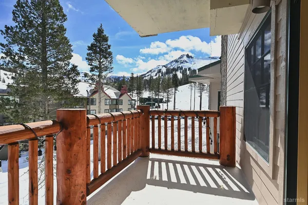 a view of a balcony with wooden floor