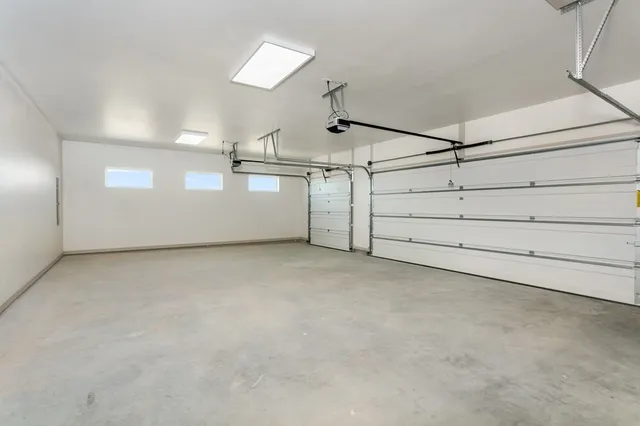 a kitchen with stainless steel appliances kitchen island granite countertop a sink and a refrigerator