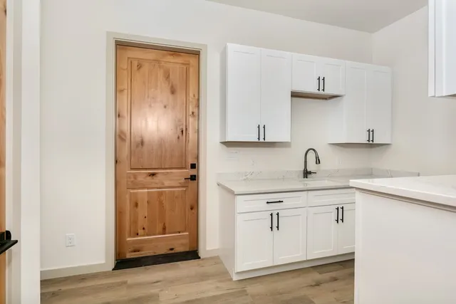 a view of walk in closet with empty racks