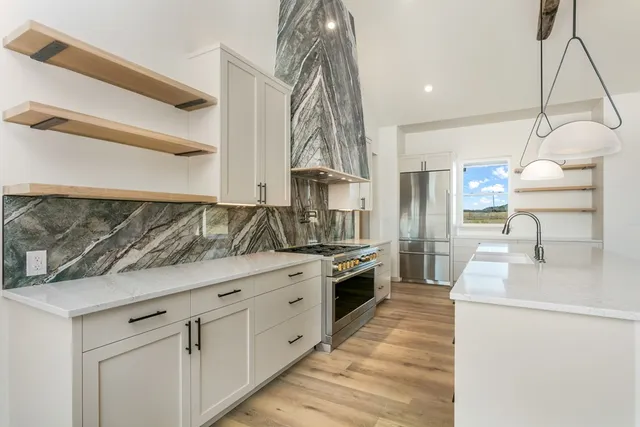 a kitchen with sink cabinets and stove