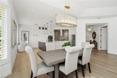 a view of a dining room with furniture and chandelier