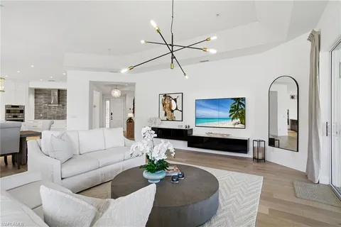 a living room with furniture a ceiling fan and a rug