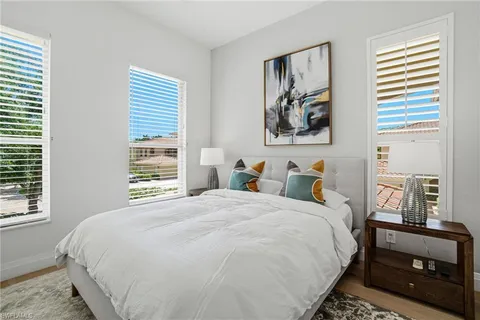 a bedroom with bed and a window