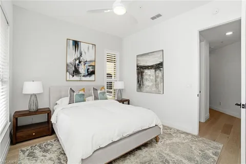 a bedroom with a bed and a lamp