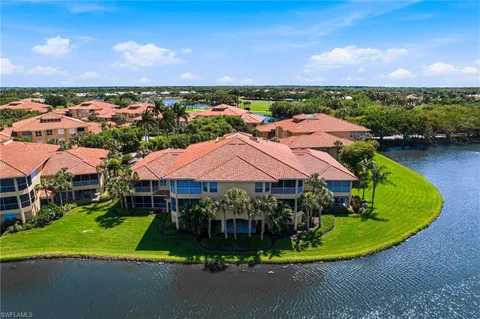 an aerial view of a house with a garden and lake view