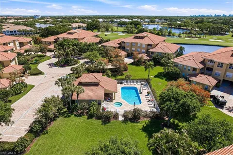 an aerial view of residential houses with outdoor space and river