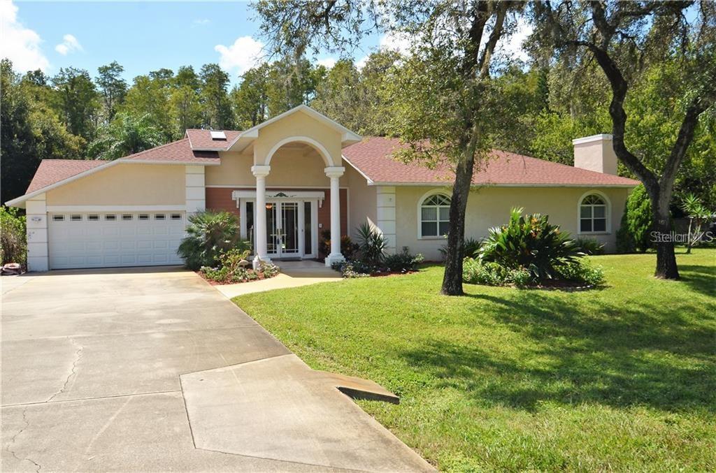 6330 Ridge Top Drive New Port Richey, FL 34655 - Photo 1 of 1 a front view of a house with garden