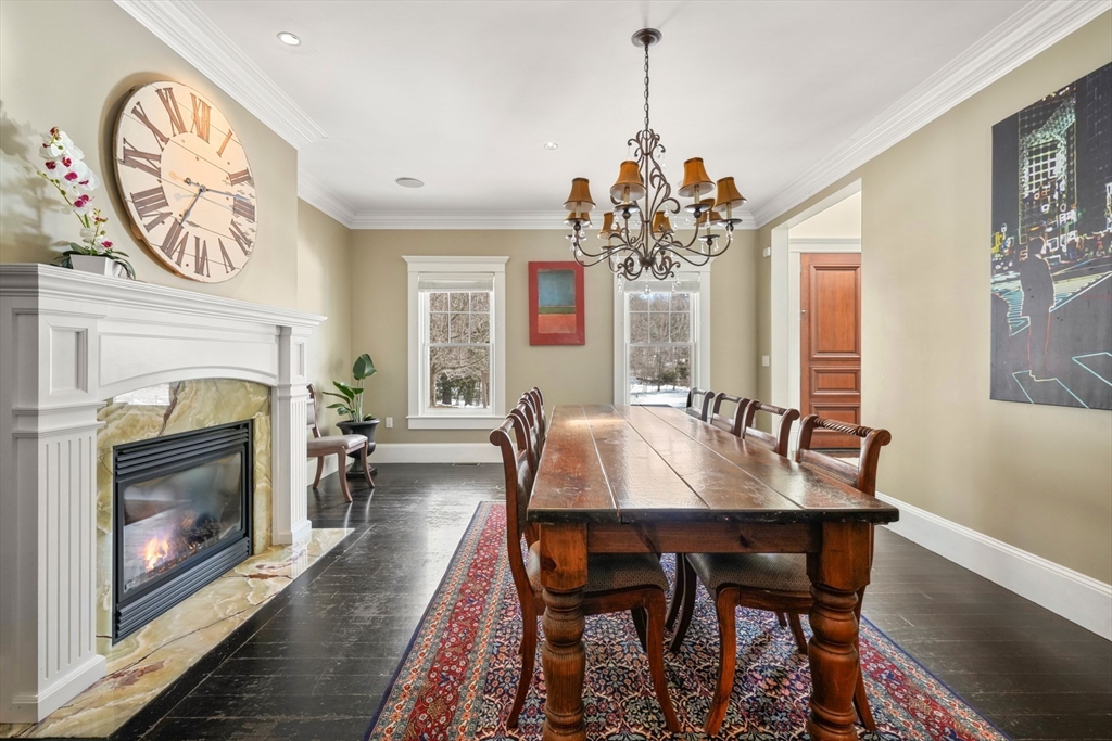 427 Hillside Street Milton, MA 02186 - Photo 9 of 42 a view of a dining room with furniture and a fireplace