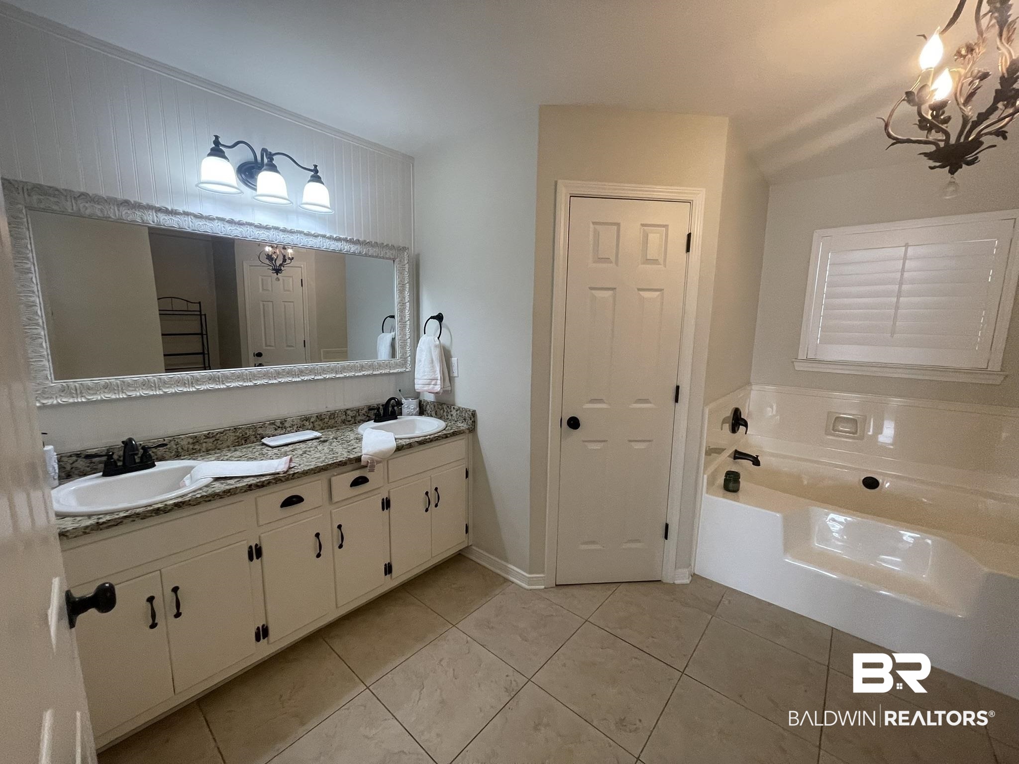35405 Pine Road South Stapleton, AL 36578 - Photo 14 of 29 Bathroom with a closet, double vanity, a garden tub, a chandelier, and light tile patterned floors