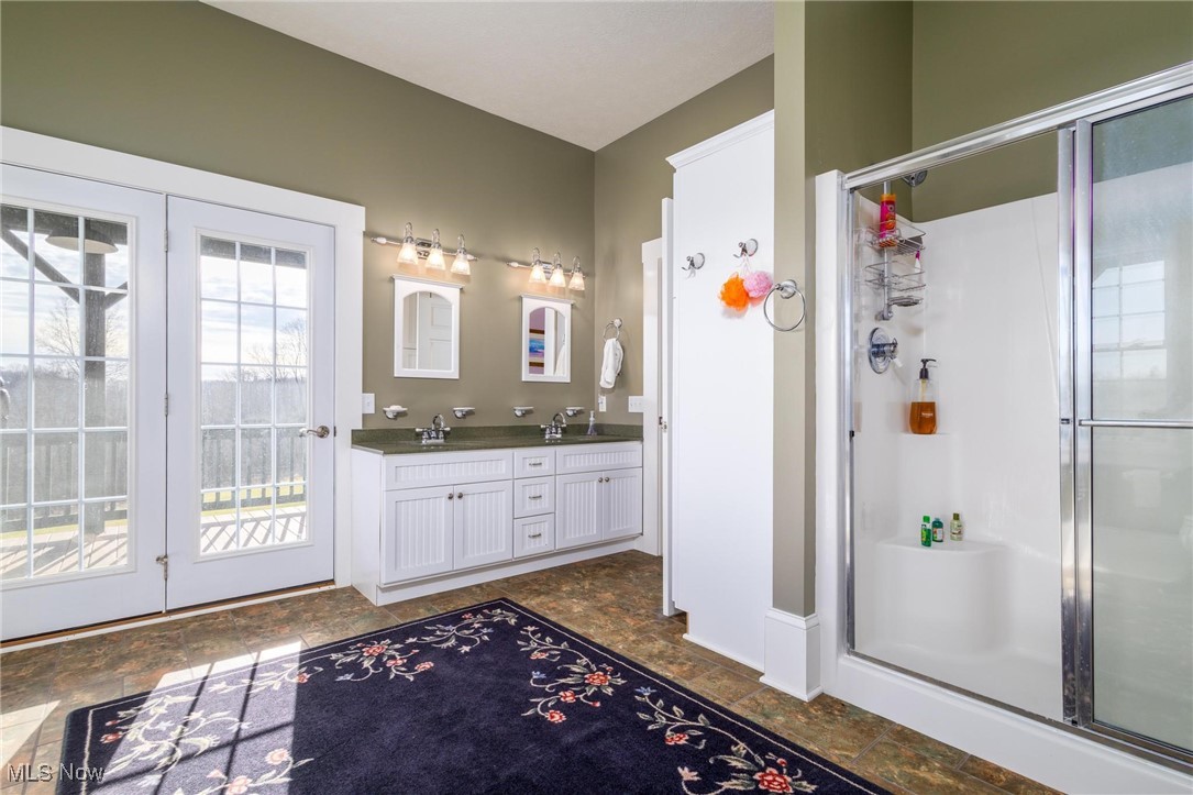 35955-35959 Bower Road Scio, OH 43988 - Photo 13 of 50 Bathroom featuring dual vanity, a shower with shower door, tile floors, and plenty of natural light