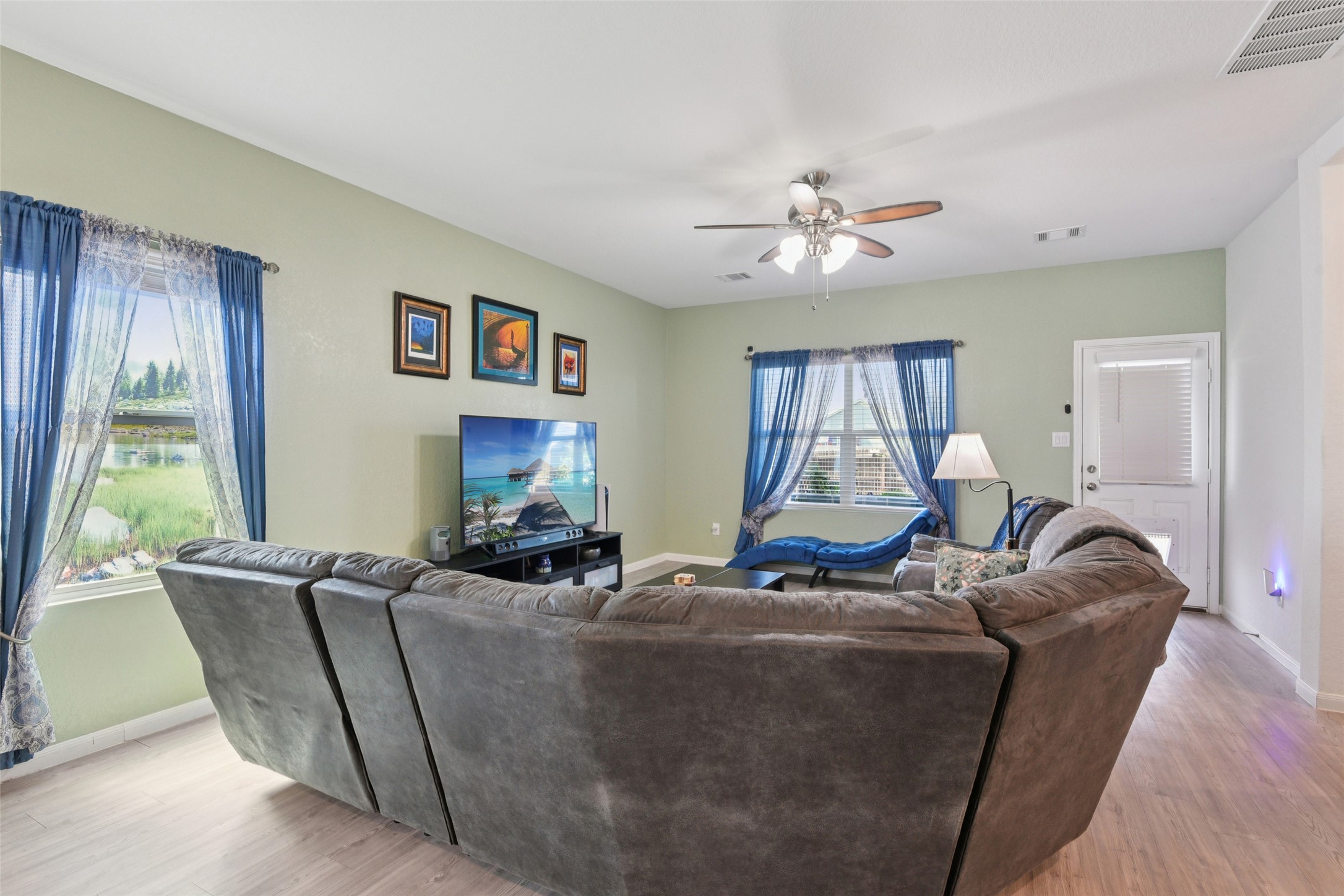 9058 Bowie Ridge Seguin, TX 78155 - Photo 13 of 40 Living area with light wood finished floors and a ceiling fan