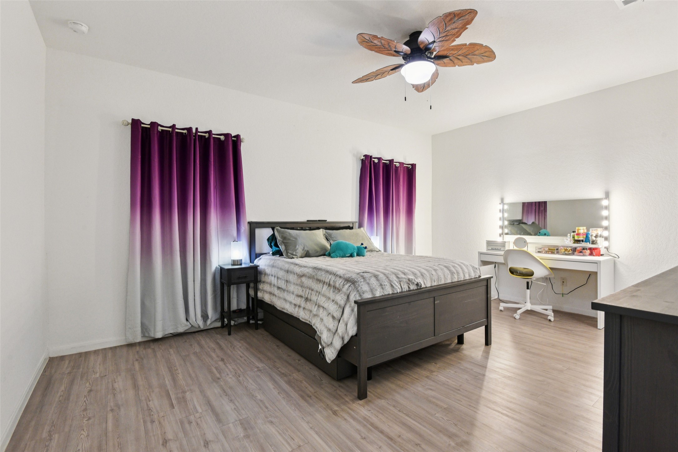 9058 Bowie Ridge Seguin, TX 78155 - Photo 17 of 40 Bedroom with light wood-type flooring and a ceiling fan