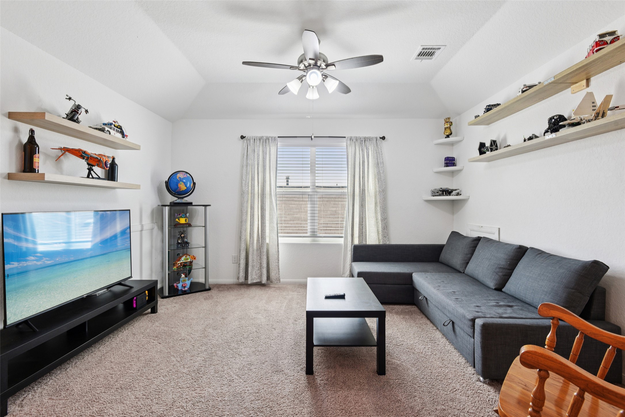 9058 Bowie Ridge Seguin, TX 78155 - Photo 21 of 40 Living area with lofted ceiling, ceiling fan, and light colored carpet