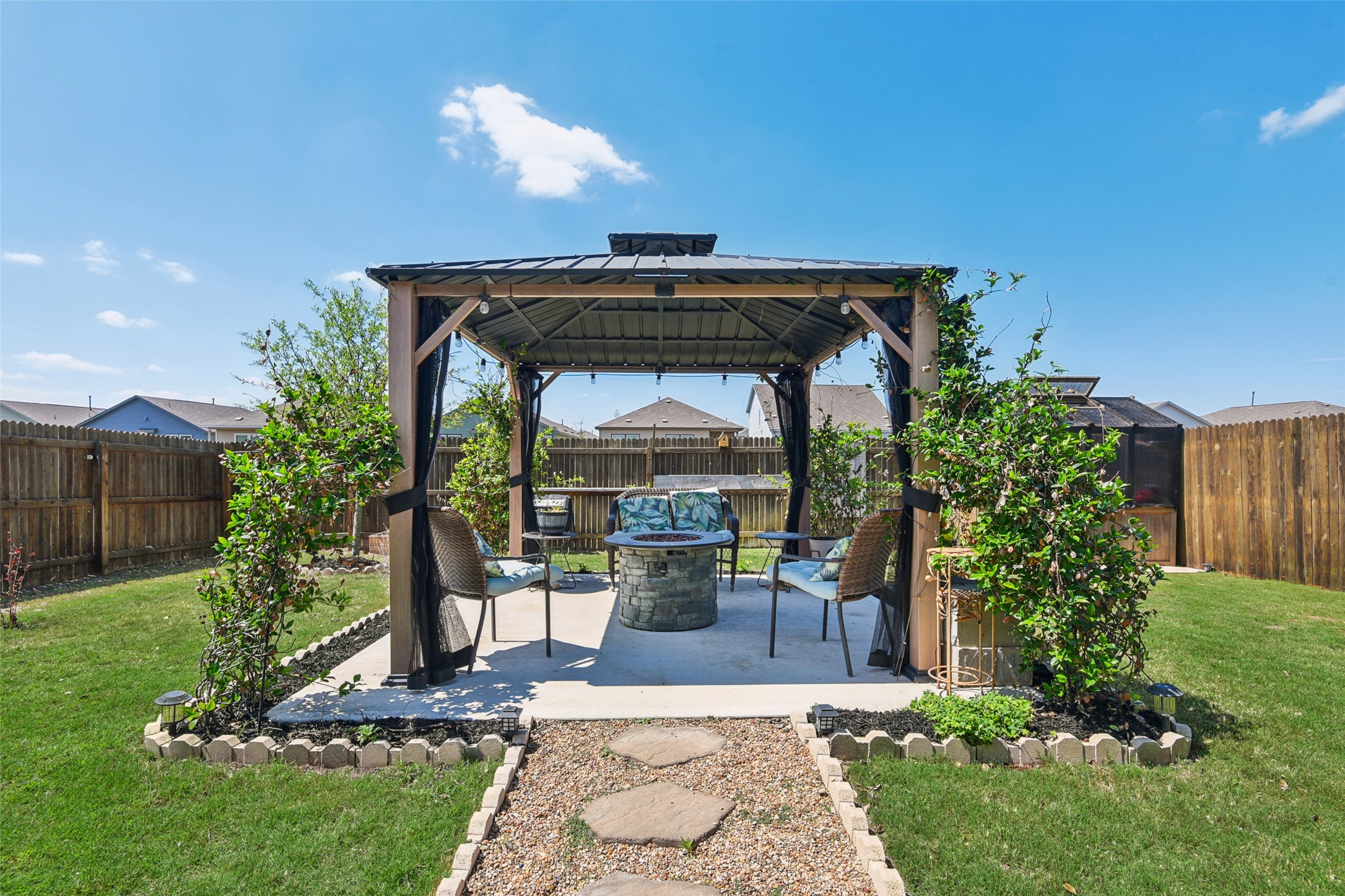 9058 Bowie Ridge Seguin, TX 78155 - Photo 31 of 40 Fenced backyard featuring a gazebo, a fire pit, and a patio