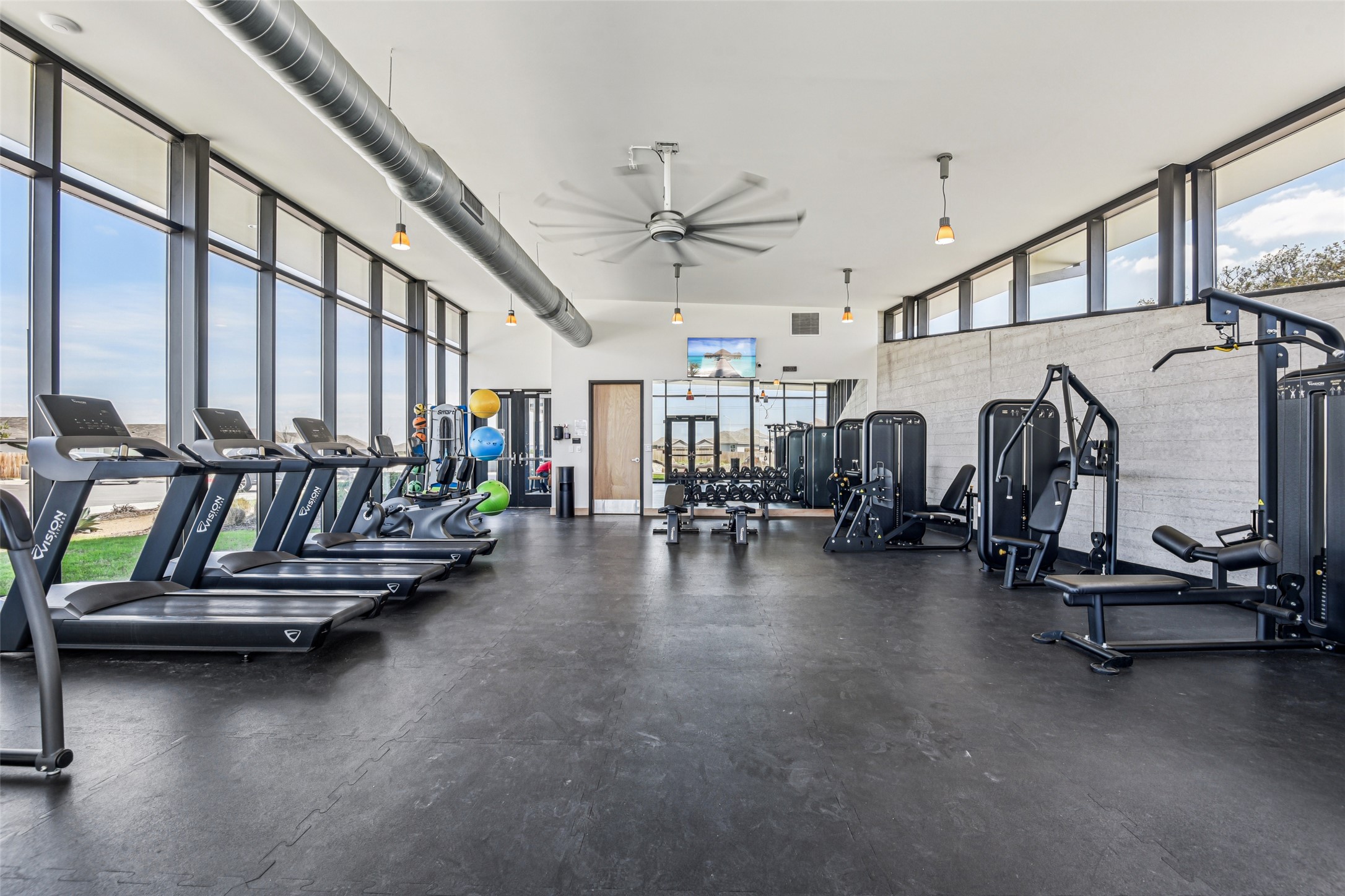 9058 Bowie Ridge Seguin, TX 78155 - Photo 36 of 40 Workout area with a ceiling fan and expansive windows