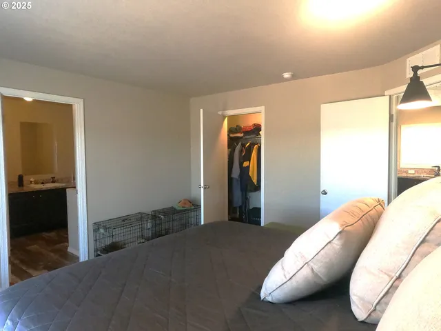 a bedroom with bed and a large mirror