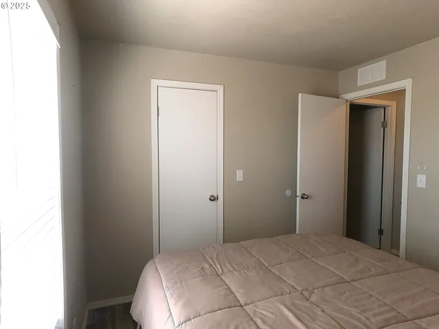 a bedroom with a bed and a closet