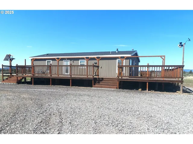 a view of a house with wooden fence