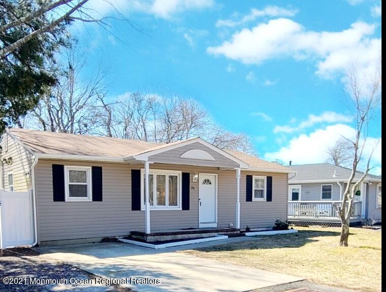 34 Letts Landing Road Waretown, NJ 08758 - Photo 1 of 23 a view of a white house with large windows next to a road