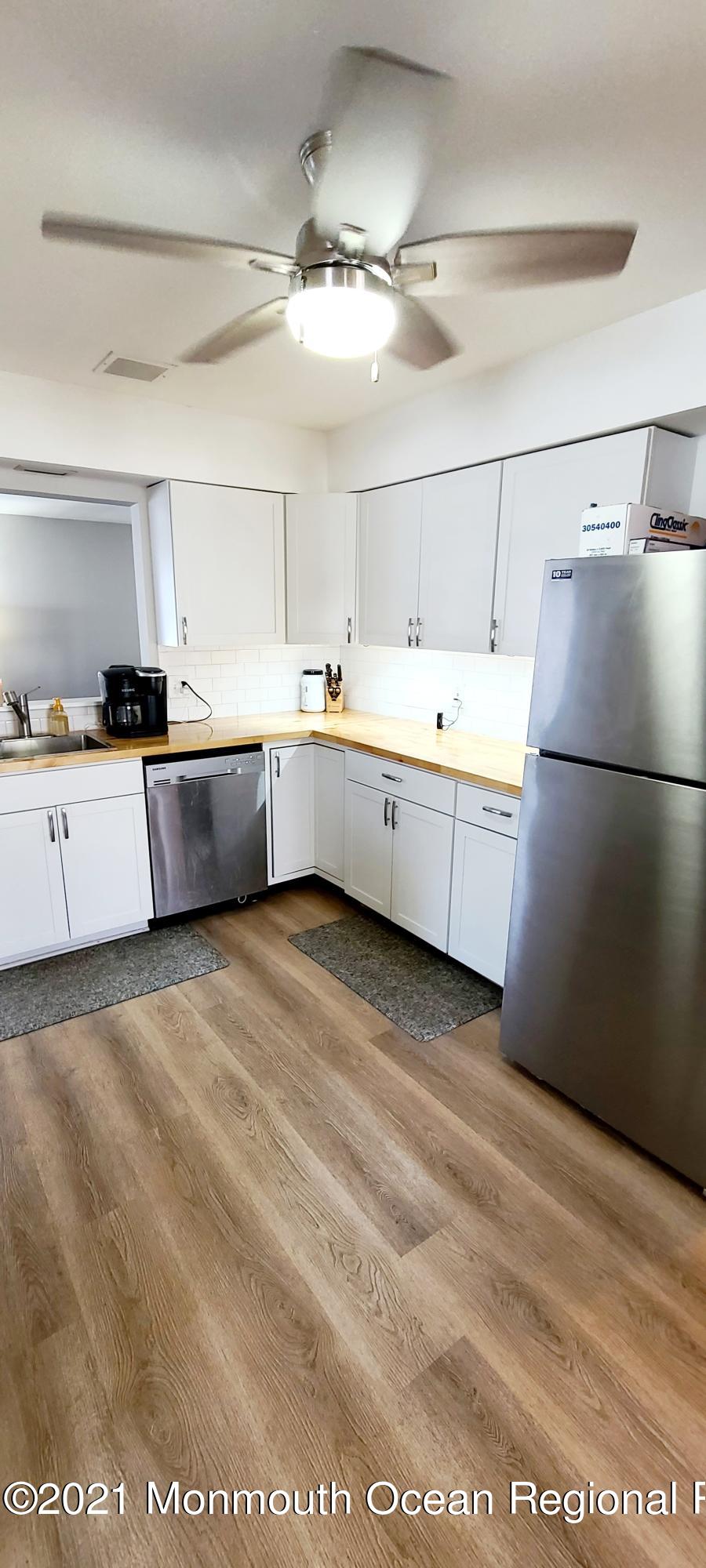 34 Letts Landing Road Waretown, NJ 08758 - Photo 11 of 23 a large white kitchen with a refrigerator a stove top oven a sink and dishwasher