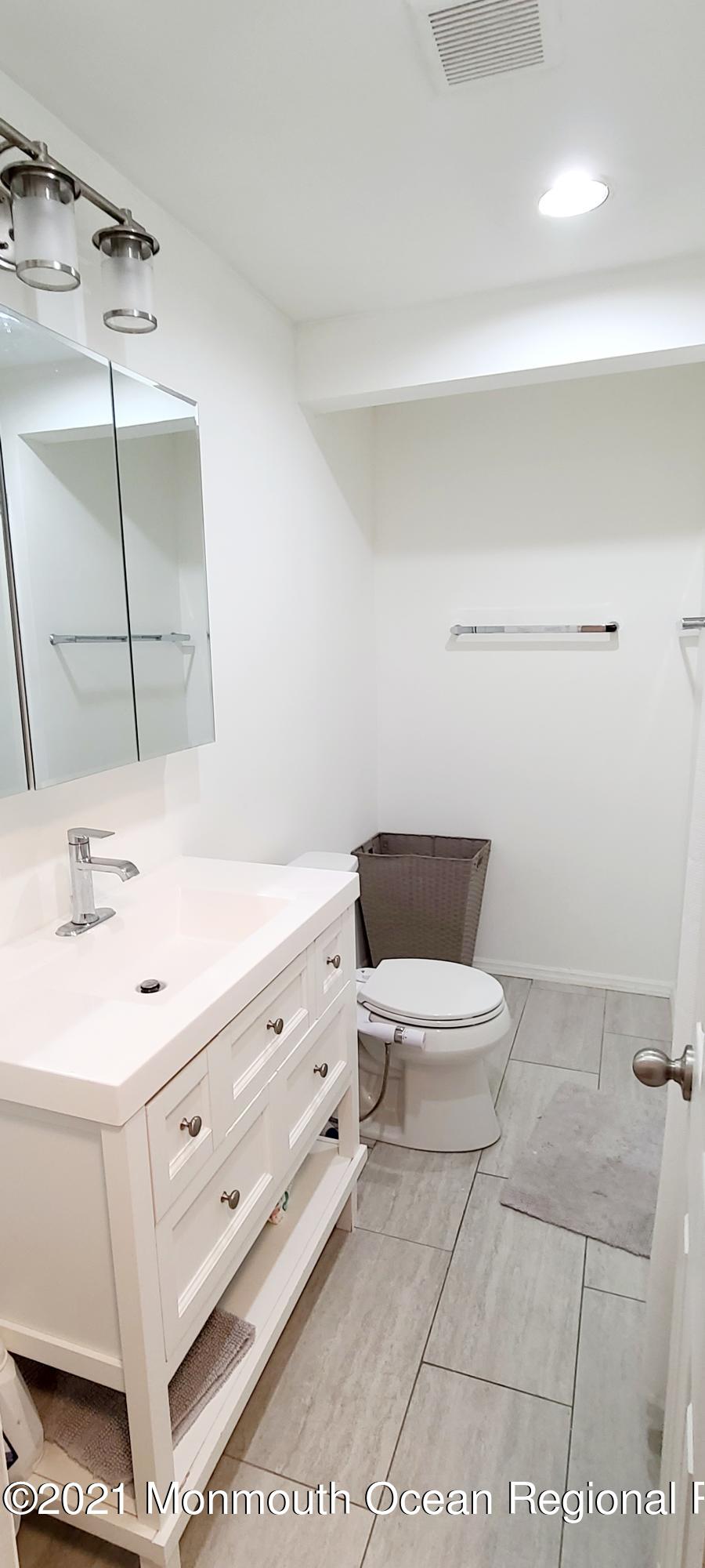 34 Letts Landing Road Waretown, NJ 08758 - Photo 14 of 23 a bathroom with a sink a toilet and mirror