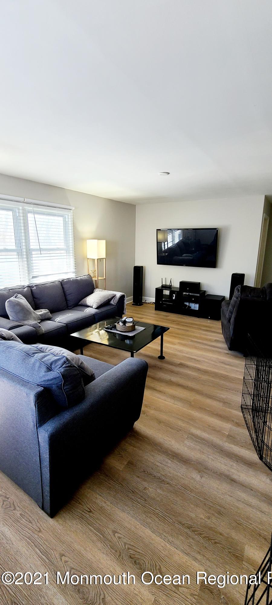 34 Letts Landing Road Waretown, NJ 08758 - Photo 16 of 23 a living room with furniture and a flat screen tv