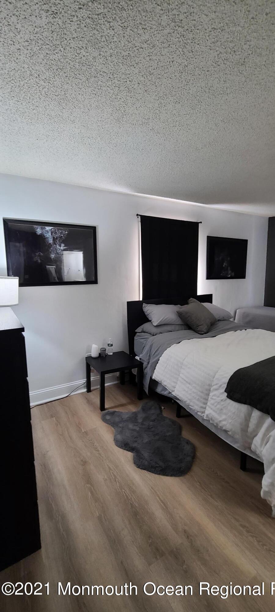 34 Letts Landing Road Waretown, NJ 08758 - Photo 18 of 23 a bedroom with a bed and a flat screen tv
