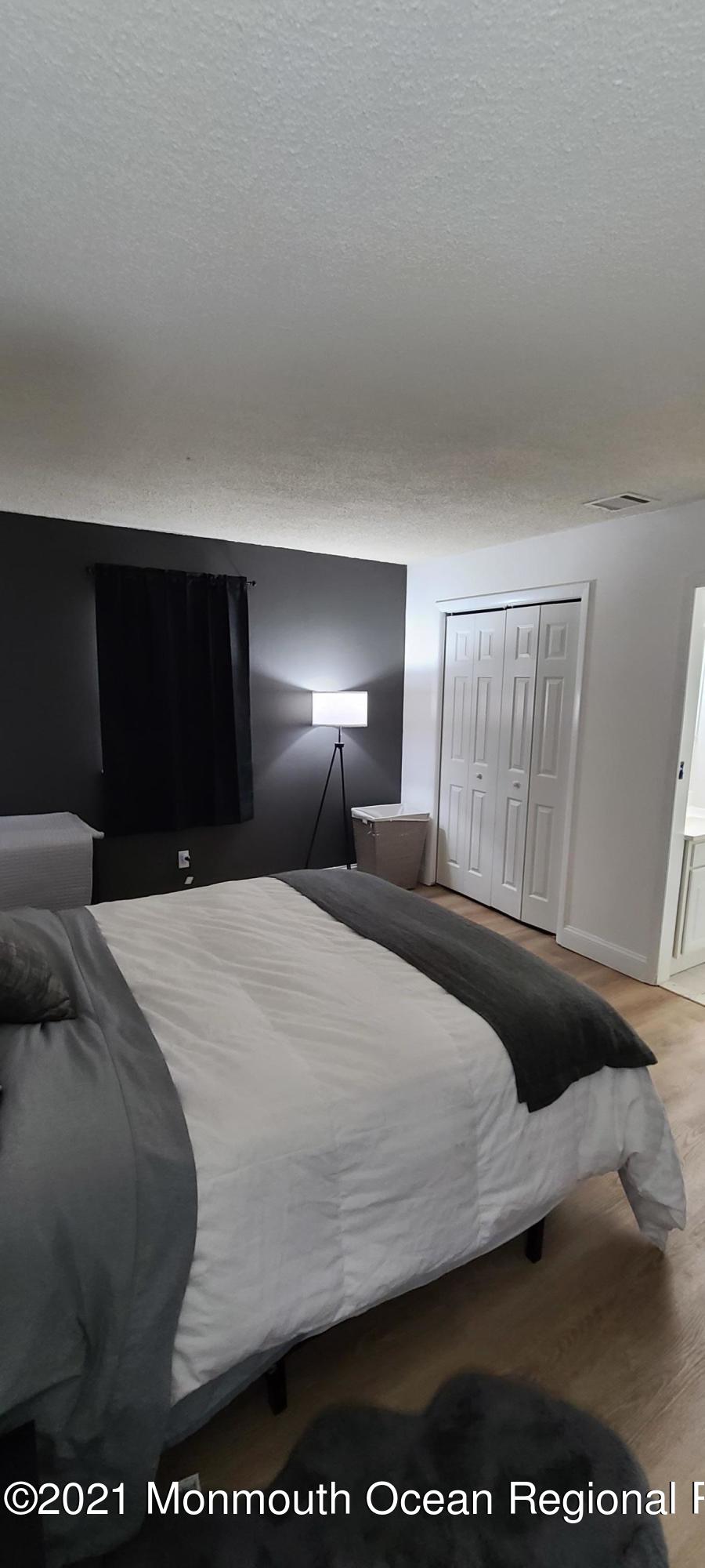 34 Letts Landing Road Waretown, NJ 08758 - Photo 19 of 23 a bedroom with a bed and a large window