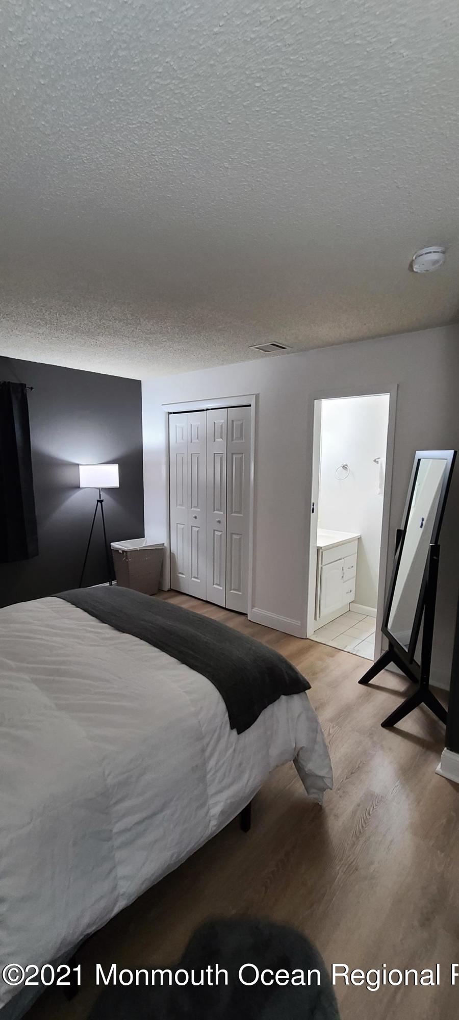 34 Letts Landing Road Waretown, NJ 08758 - Photo 20 of 23 a bedroom with a bed a mirror and gym equipment