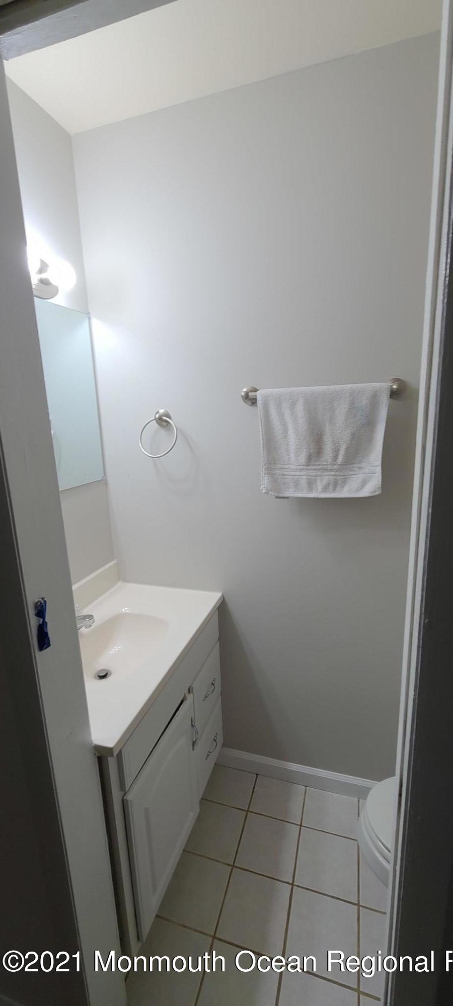 34 Letts Landing Road Waretown, NJ 08758 - Photo 21 of 23 a bathroom with a sink a toilet and mirror