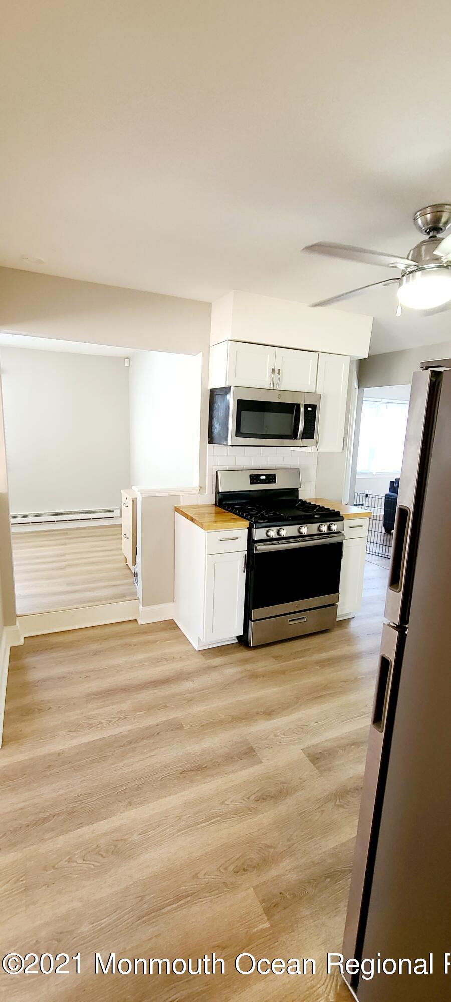 34 Letts Landing Road Waretown, NJ 08758 - Photo 9 of 23 a view of kitchen with microwave stove refrigerator and cabinets