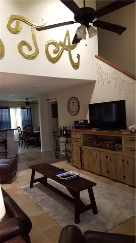 a living room with furniture pool and a flat screen tv