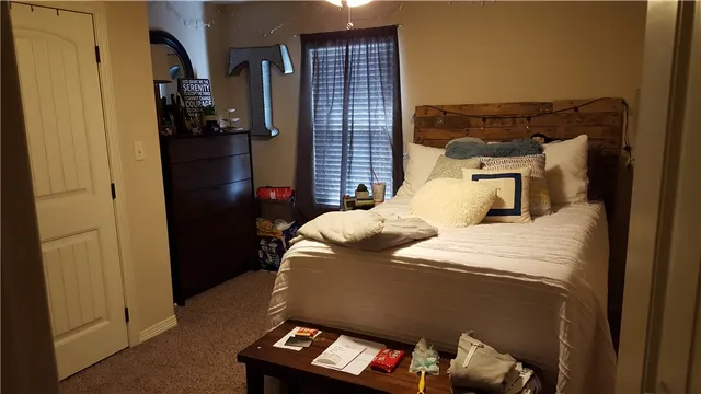 a bedroom with a bed and a tv
