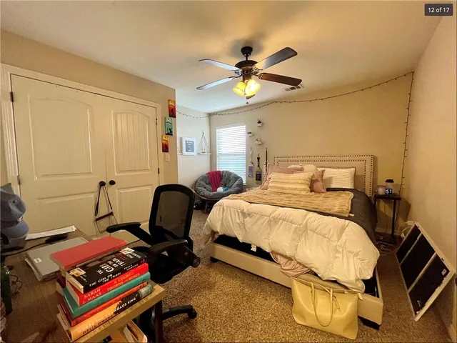 a bathroom with a granite countertop toilet sink and mirror