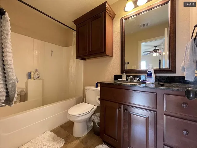 a spacious bedroom with a bed and ceiling fan