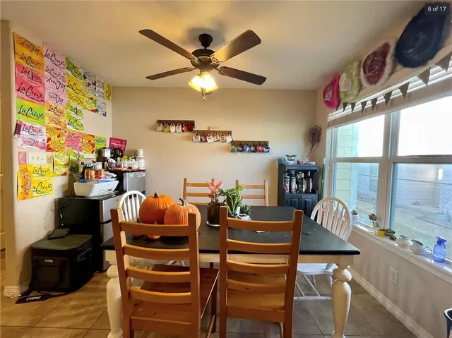 a dining room with furniture and a chandelier