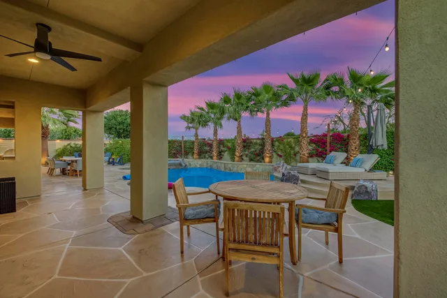 a view of a dining room with furniture wooden floor and a large window