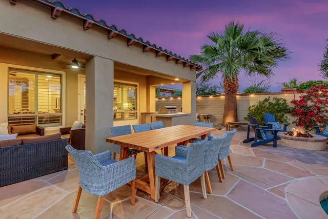 a bedroom with a bed a dresser and flat screen tv