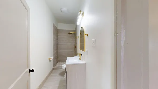 a bathroom with a sink a mirror and a shower