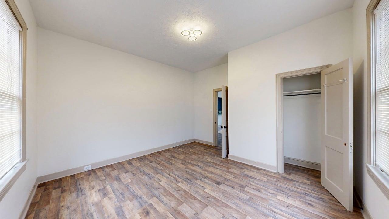 860 Stokes Street Danville, VA 24541 - Photo 16 of 32 an empty room with wooden floor and windows