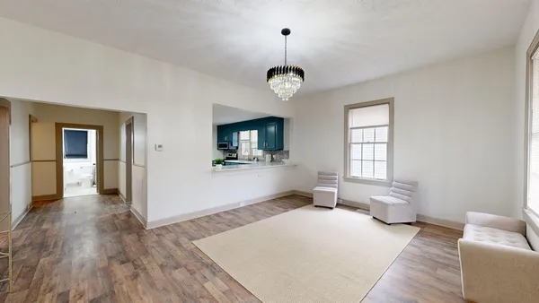 a living room with furniture wooden floor and a window