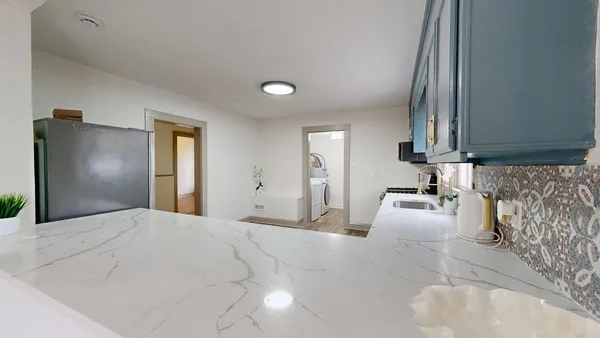 a large white room with mirror and view