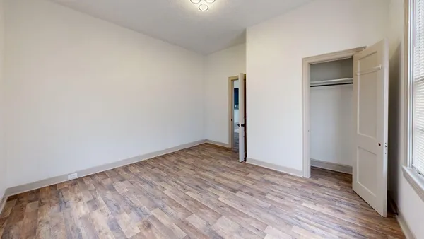 a view of an empty room and wooden floor