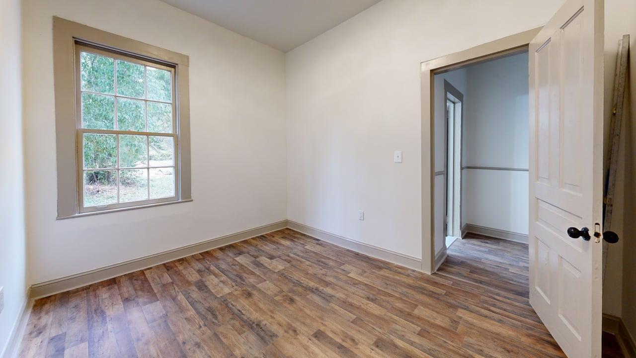 860 Stokes Street Danville, VA 24541 - Photo 25 of 32 an empty room with wooden floor closet and windows