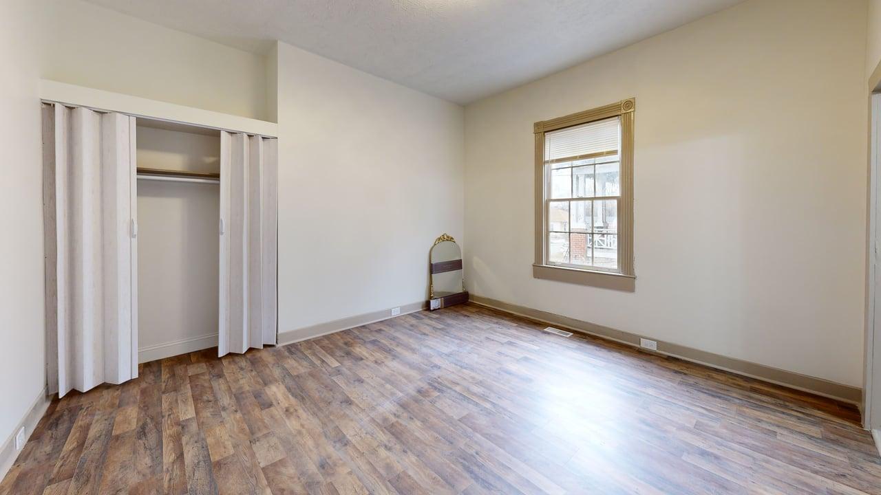 860 Stokes Street Danville, VA 24541 - Photo 26 of 32 an empty room with wooden floor and windows