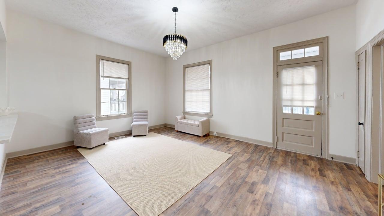 860 Stokes Street Danville, VA 24541 - Photo 28 of 32 an empty room with wooden floor and windows