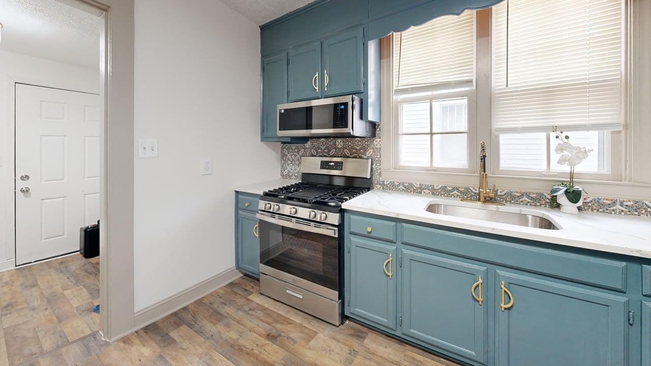 860 Stokes Street Danville, VA 24541 - Photo 29 of 32 a kitchen with stainless steel appliances granite countertop a sink stove and refrigerator
